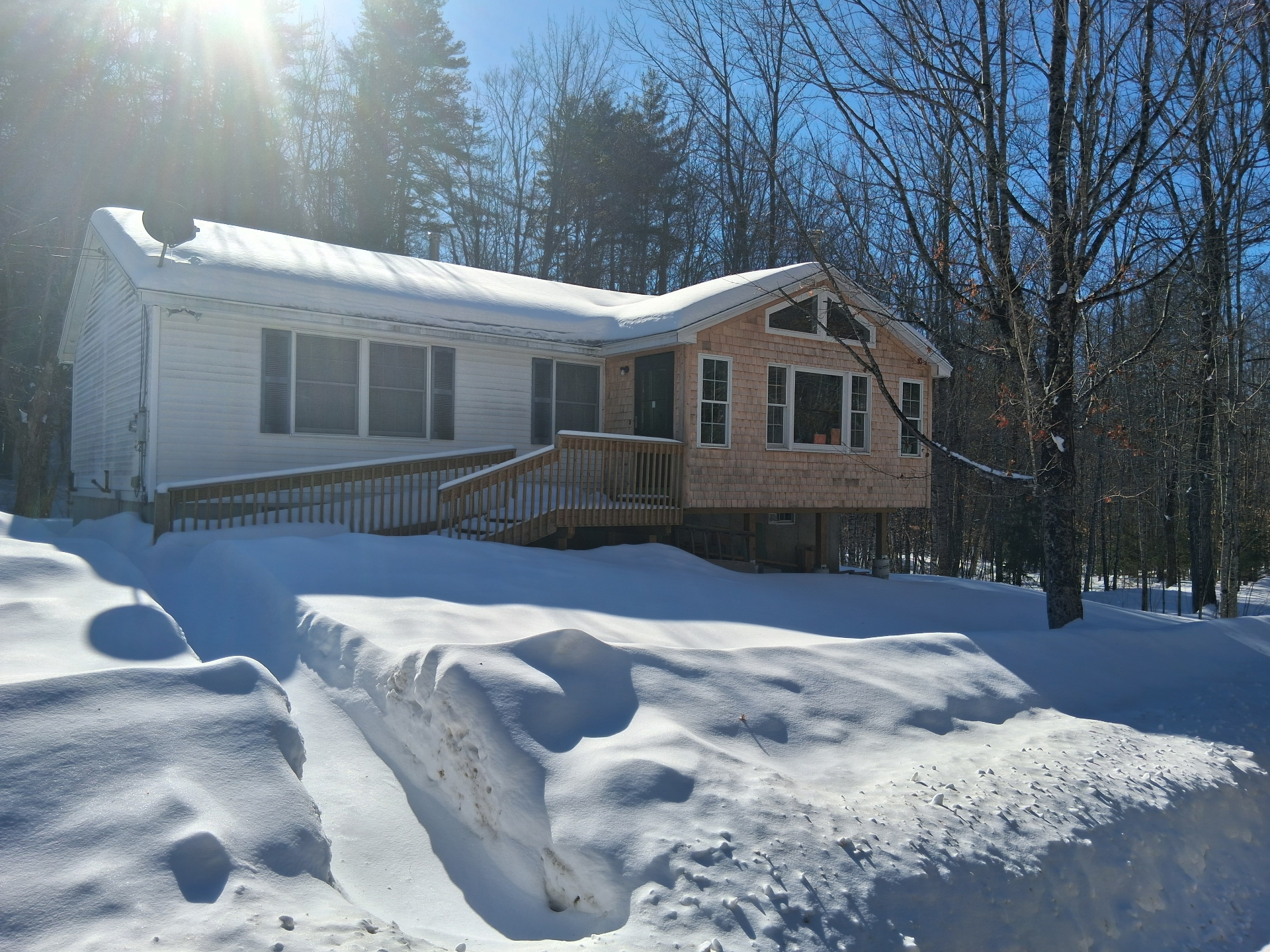 A custom home addition built by Mountain Pass Contracting, Building & Remodeling in the New Hampshire snow